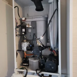 Interior view of a heating boiler showing various components and wiring.