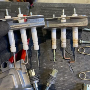 Two sets of plumbing components with various fittings and connectors on a work surface.